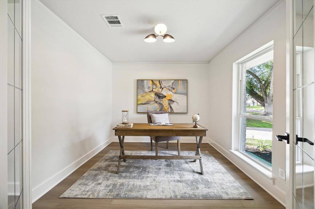 ENTER THE PRIVATE HOME STUDY THROUGH LEAD PANELED FRENCH DOORS. THE PERFECT PLACE TO WORK FROM HOME.
