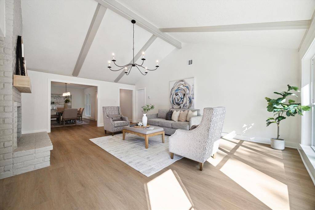 THIS OPEN FLOOR PLAN IS HIGHLY DESIRABLE. NOTICE THE MODERN CHIC CHANDELIER. THE LIGHT FIXTURES THROUGHOUT THE HOME WERE HAND PICKED BY "MAVERICK" DESIGN.