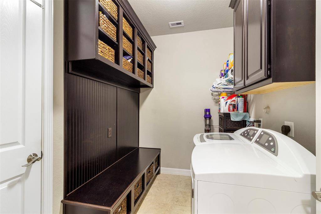 The laundry room features tile floors,washer and dryer connections, andplenty of storage space.
