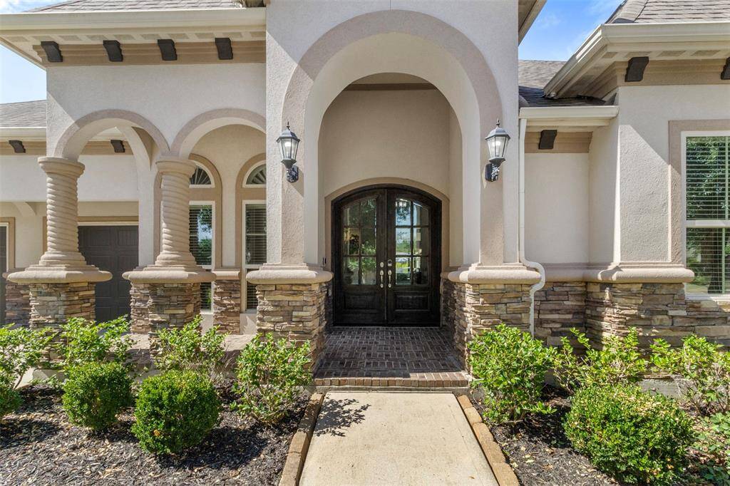 Approaching the front door you will see the lovely landscaping and covered front porch.