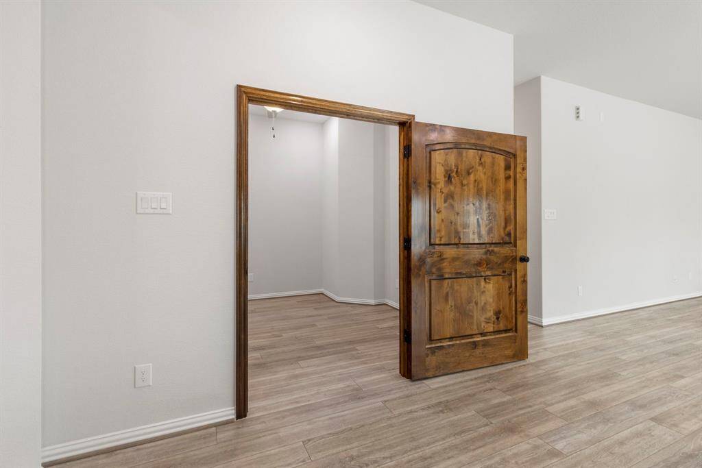 Behind this solid wood door is a flexible media or private study room.