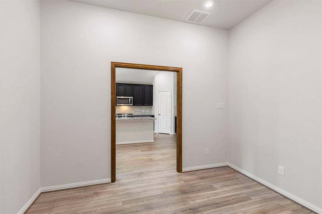 The custom wooden doorframe adds character to this private flexible space, right outside of the main living area.