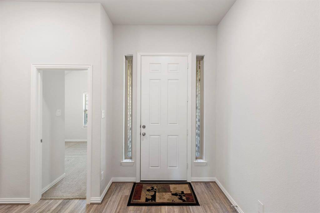 To the right of the front door is a spacious bedroom and an adjacent bathroom.