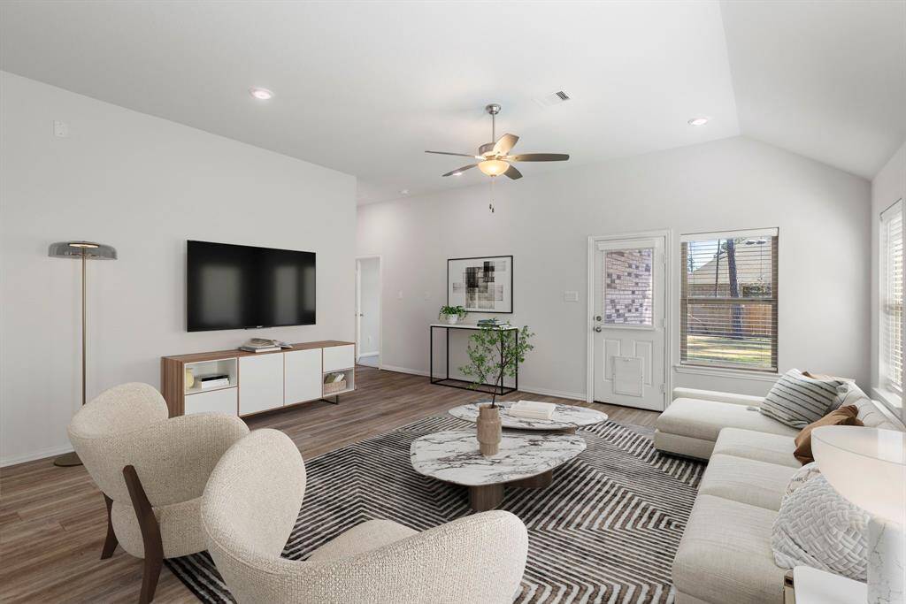 This virtually staged living room shows you what is possible with the flexibility of the space. There is light sources from the windows, ceiling fan, and recessed lights.