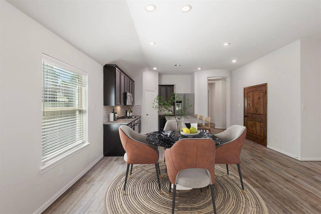 This virtually staged dining area has a large window for natural light.