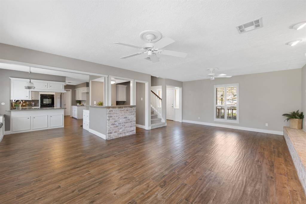 The dry bar area is highlighted by a beautiful brick accent, adding a touch of rustic charm and warmth to the space. This thoughtful detail enhances the overall aesthetic, making it a standout feature in the home.