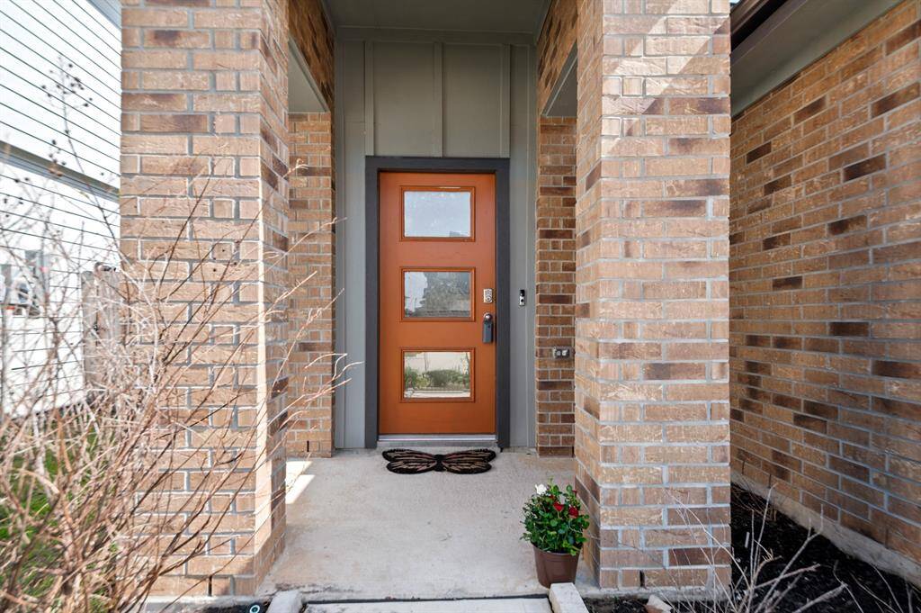 Stylish and modern front door with a covered porch.
