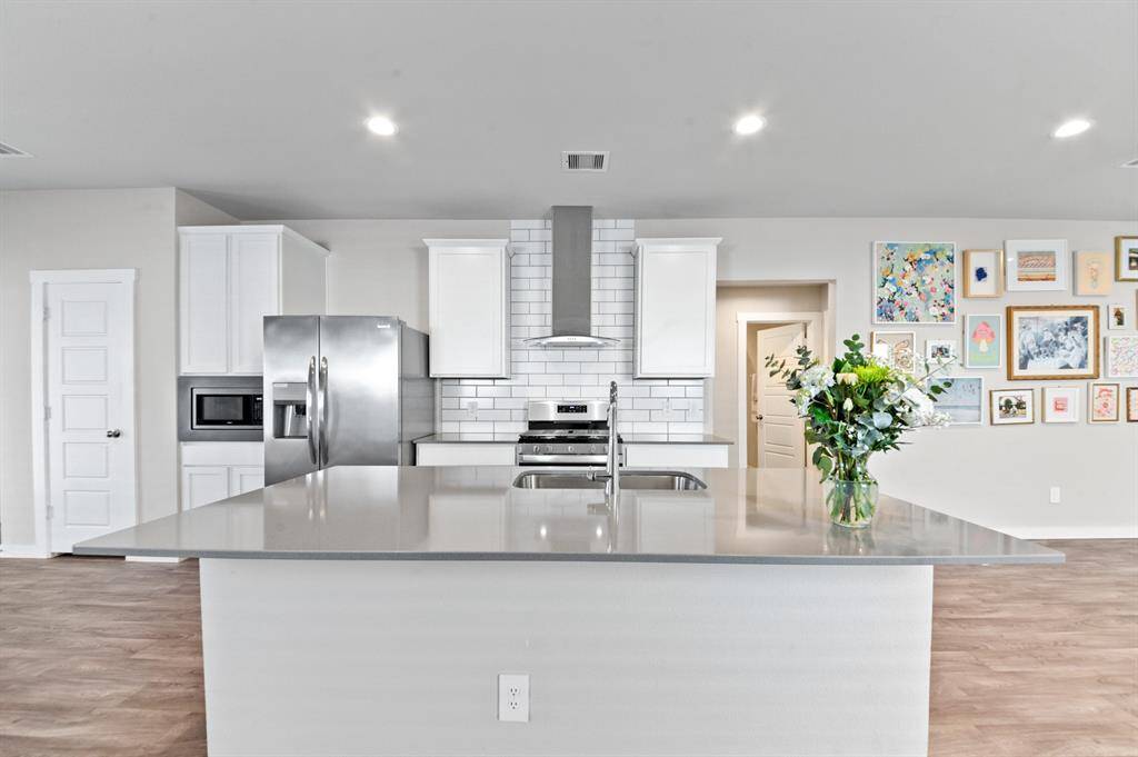 This home features a beautiful kitchen with a large island that anchors the open concept space. It provides additional seating space as well.