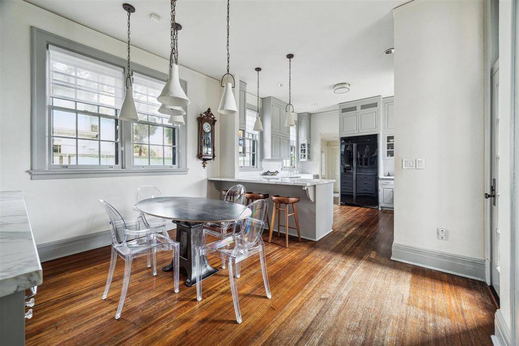Entering into the chef's wing of the home, you are greeted by a cozy breakfast area that seamlessly flows into the bright kitchen, featuring sleek cabinetry and a functional layout.