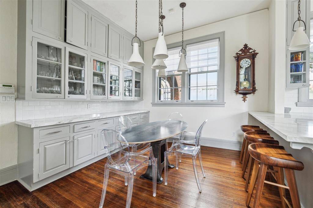 The breakfast area offers built-in cabinetry, funnel pendants, and a sidebar for ample storage and effortless serving, complemented by a convenient breakfast bar seating option.