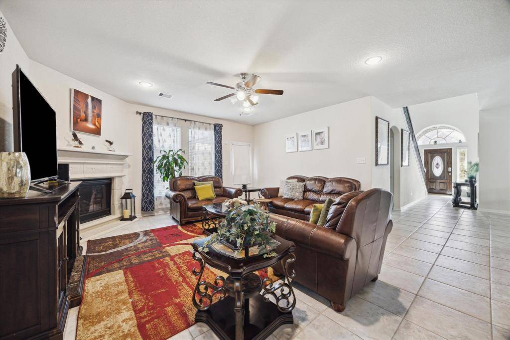 The living room features a gas log fireplace and an open floor plan.