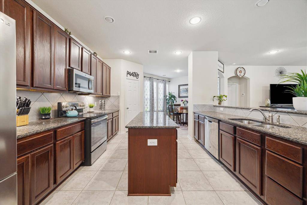 The kitchen is large and features a walk-in pantry and a center island.