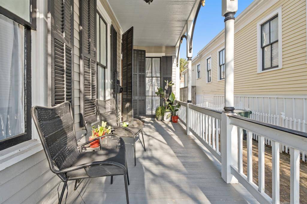 Large entry porch with beautiful wood shutters on all windows.
