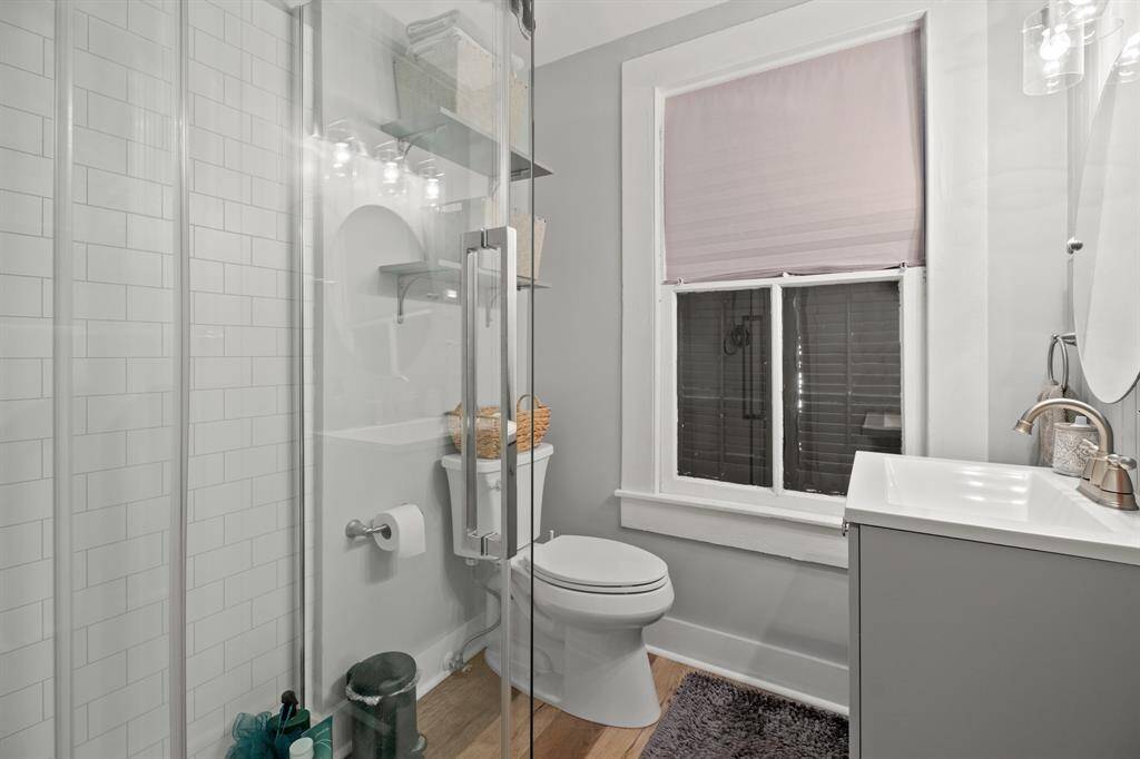 Full bath in apartment with glassed shower.