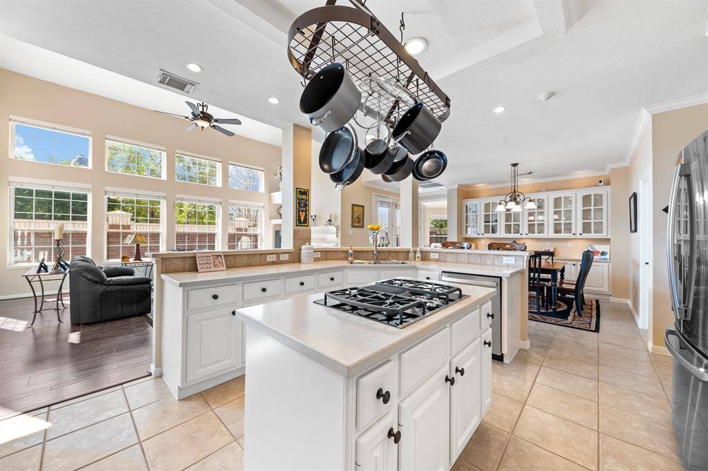 The kitchen is centrally located between the living room and the breakfast area in this very open floor plan.