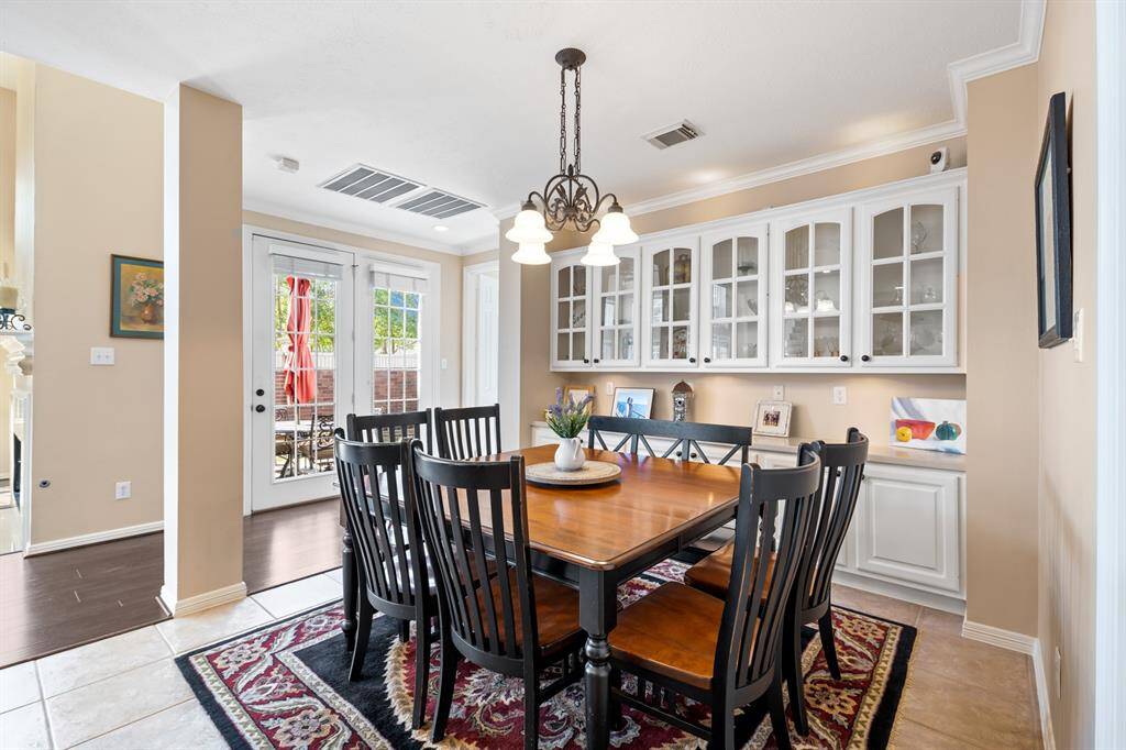 Enjoy a view of the outside while having that second cup of coffee.  This room extends your entertaining area with an attractive sideboard to display your favorite collectibles, or to display a delicious buffet!