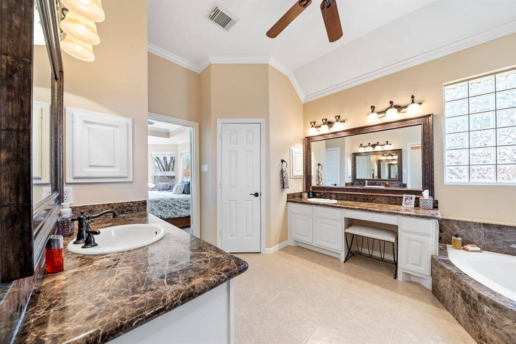 Elegant Emperador Marble grace both countertops and the sit down vanity.