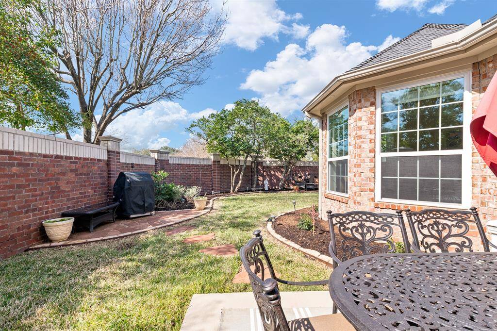 .......leading to the generous back yard. Owner has designated parts of the yard for different activities. Pictured is the grilling area, close enough to the table and guests, but just far enough away from the smoke.