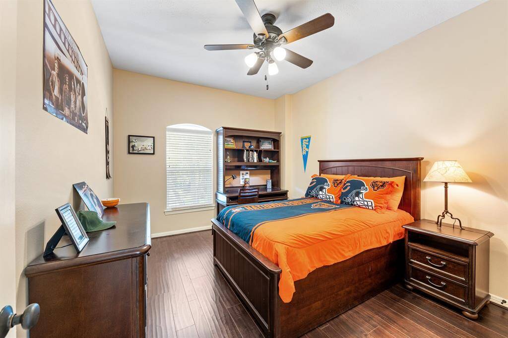 The first secondary bedroom is at the top of the stairs to the right. Both upstairs bedrooms have hardwood floors. It is directly across from the shared bathroom.