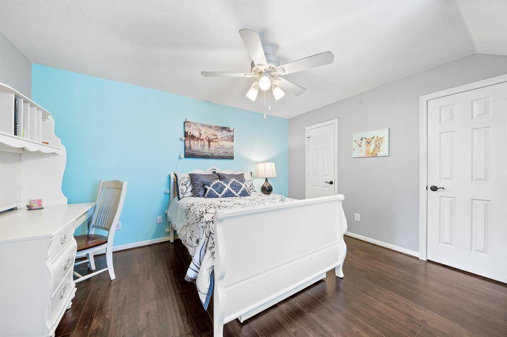 Hardwood floors and a closet that runs the length of the room.