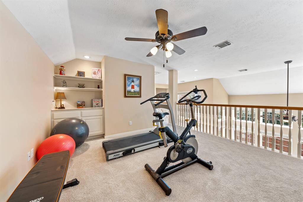 Bookshelves and cabinets add to the storage in this room.