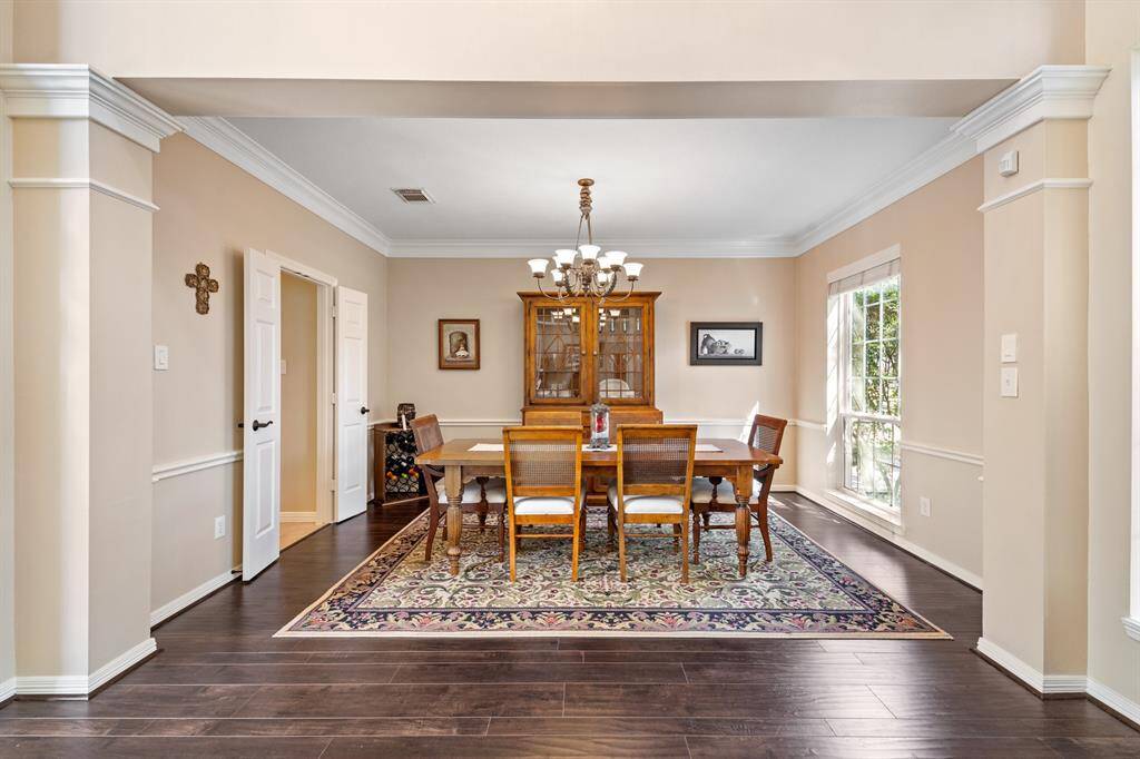 A formal dining room perfect for enjoying those holiday gatherings! The double doors visible in the photo open to the hallway which leads to the powder room and the kitchen.