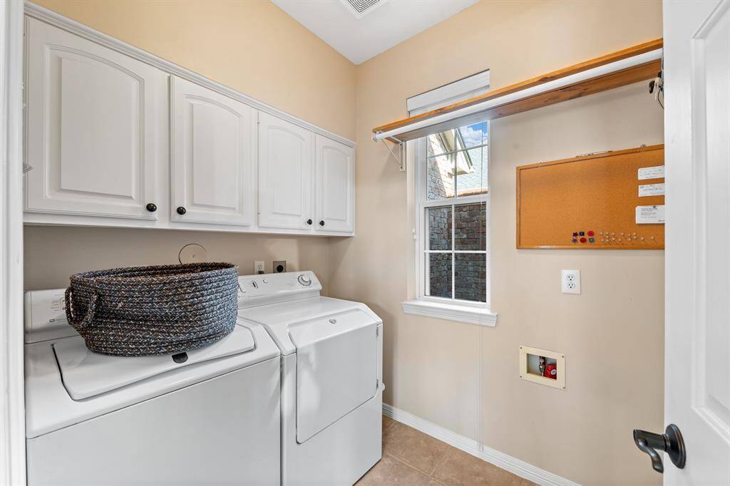 A good size and practical, the laundry has built in cabinets and a hanging rod, plus a window to let in the light.