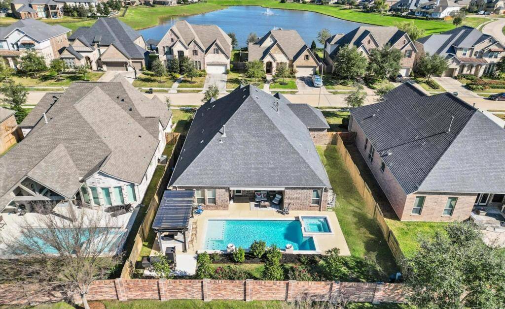 This actually might be the perfect home! Backyard oasis, featuring a sparkling swimming pool and hot tub!