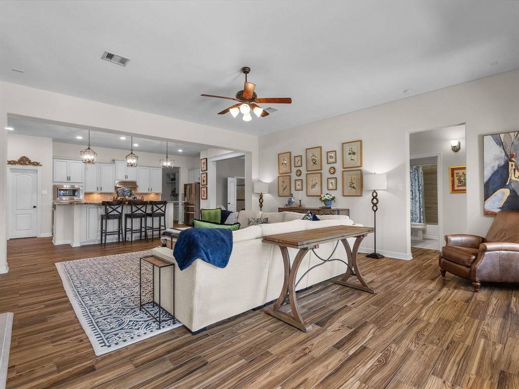 The living room offers an open layout, seamlessly connecting to the kitchen. The spacious area is perfect for entertaining and family gatherings.