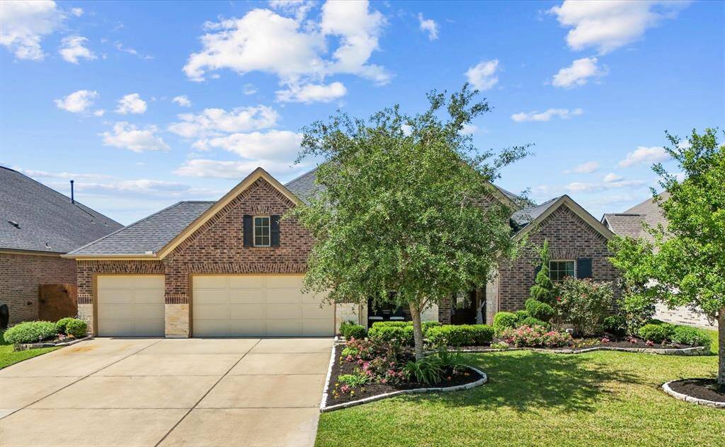 This stunning 1 story Ashton Woods home located in Hidden Lakes features well manicured front yard gardens, covered front porch and ample parking in the triple wide drive way!