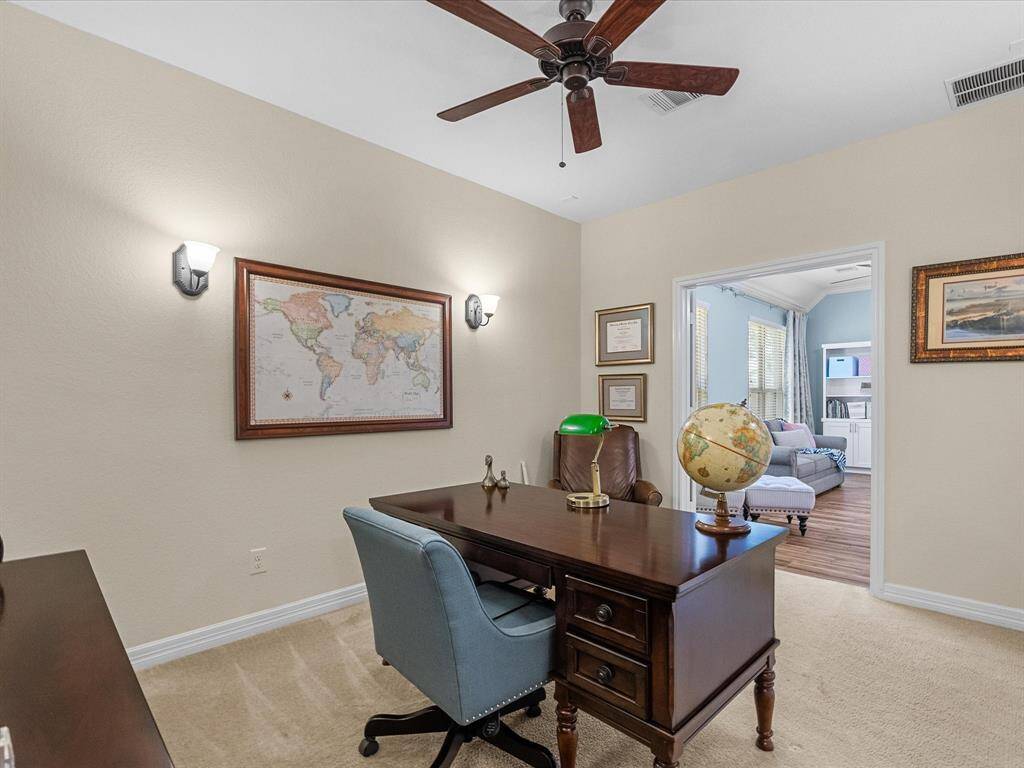 The office provides a dedicated workspace, offering a quiet and functional area. The room’s design allows for privacy while maintaining a connection to the rest of the home.
