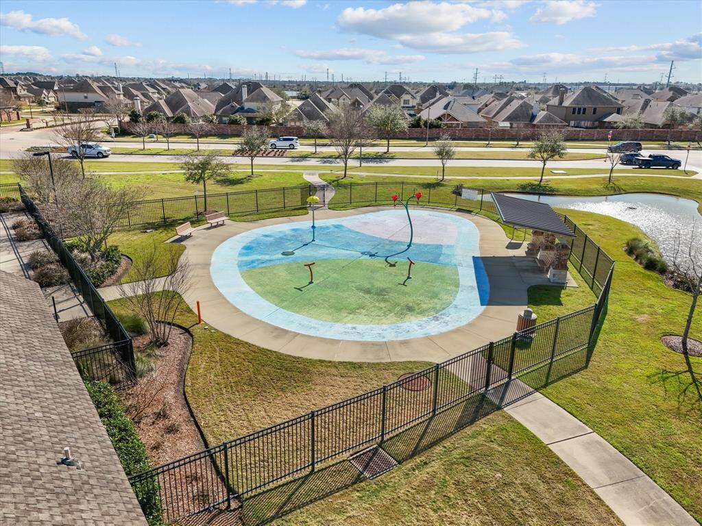 The community splash pad, picnic area, and walking paths. Fenced for safety, it offers a fun recreational space for residents.