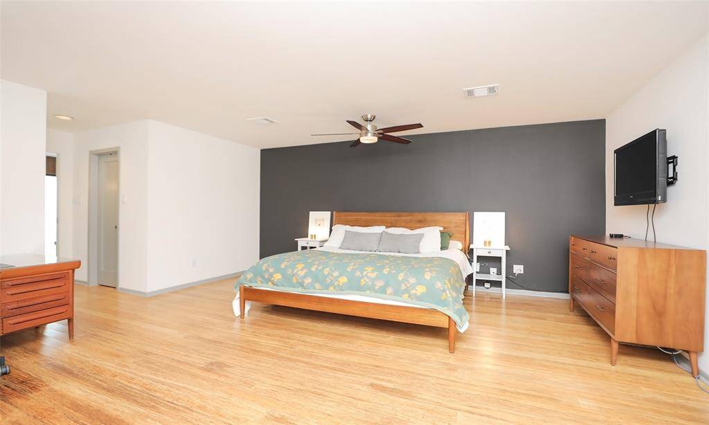 Primary bedroom is an oasis with double walk-in closets and room for an additional seating area.