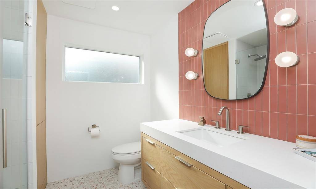 Second full bath is also beautiful with another floating vanity and modern fixtures.