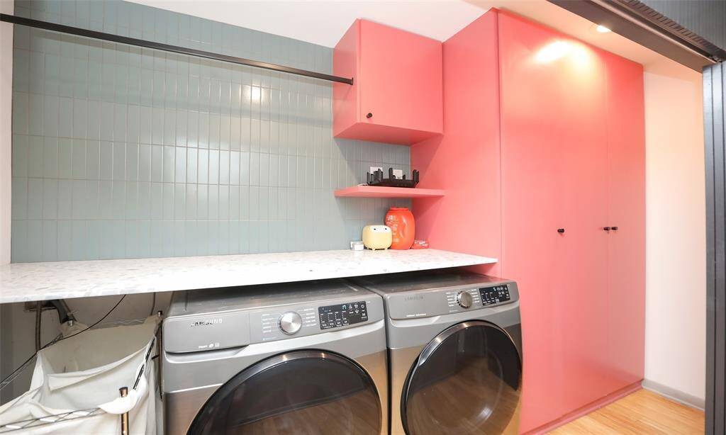 Large laundry area with additional storage and drying area.