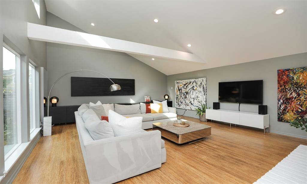 Main living area with a vaulted ceiling, wall of vindows, natural beam, and floor to ceiling fireplace. Plenty of room for any size furniture.