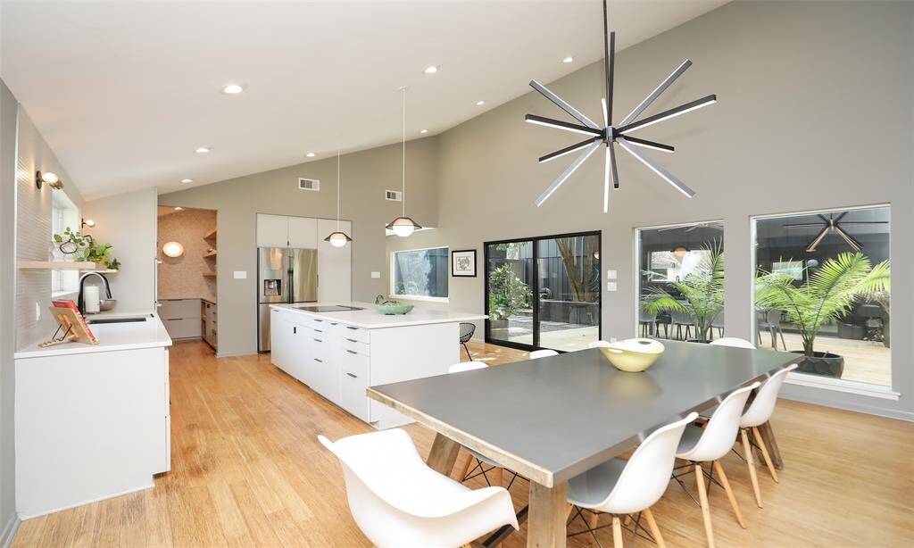 On the other side of the walk-around fireplace is the inviting kitchen area, also open to the natural interior atrium and featuring gleaming bamboo floors.