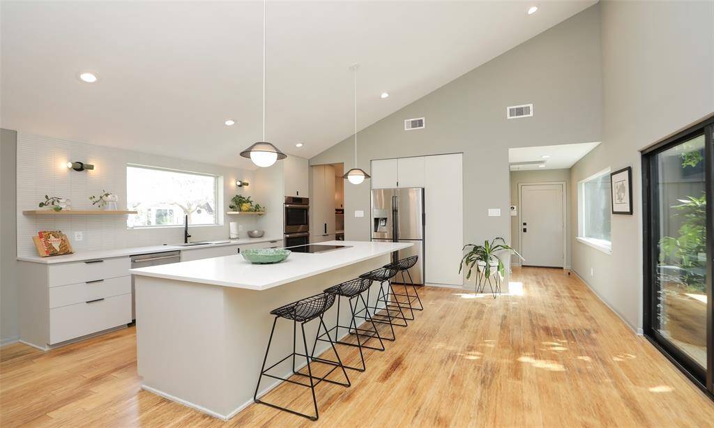 Kitchen was remodeled in 2021 to include a double oven, large quartz island with seating, convection cooktop, and every feature a chef could desire! Imagine being in this kitchen and looking out over your natural atrium in the center of your beautiful home!