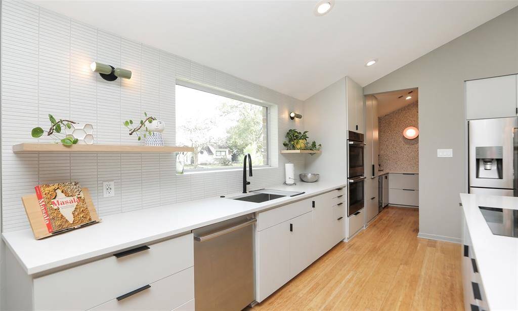 White quartz countertops and lots of windows keep this beautiful home bright and open feeling.