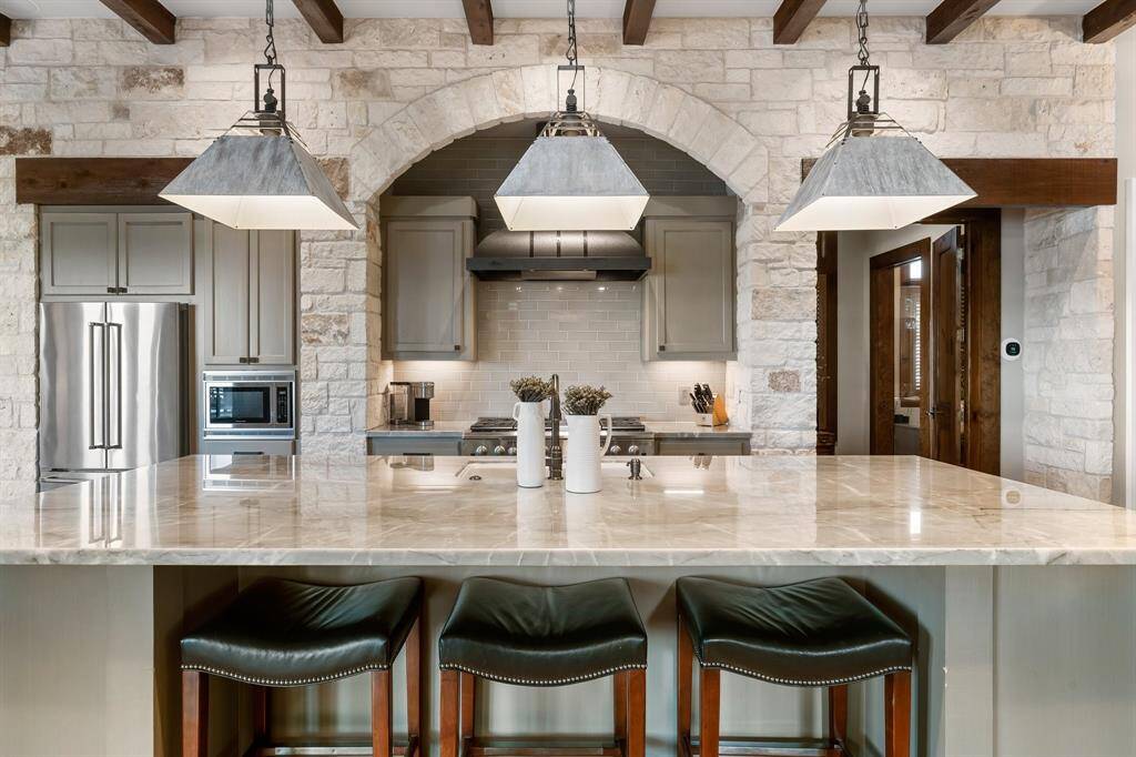 Impressive stone adorned walls and expansive marble bar and counters dress this cooking area well!