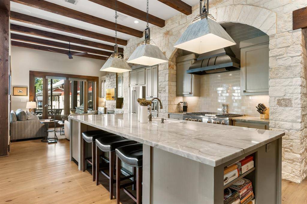 A perfect place to start the day or entertain the Chef while cooking! Stainless appliances, gas range plus griddle, 2 convection ovens, microwave by the refrigerator. Slide outs in most cabinets. There is a huge walk-in pantry for mega storaqe as well as plenty of room for a second refrigerator.