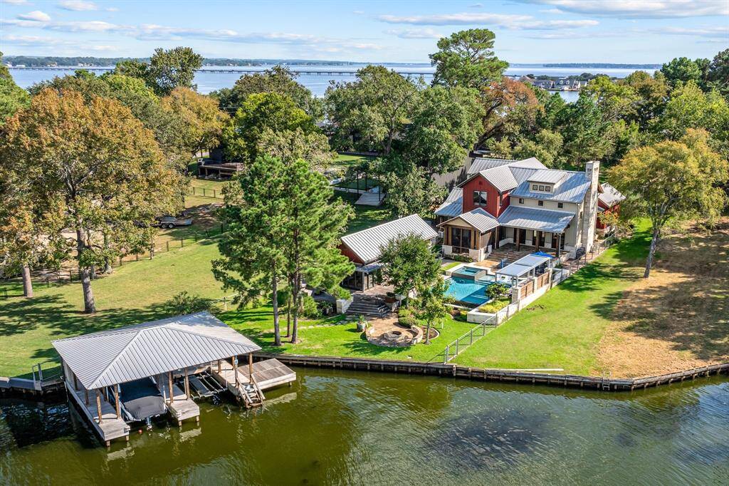This property, near the end of a peninsula on Lake Conroe offers so much more of a "Lake Lifestyle" than most !!Hurry to see this inclusive opportunity to make it your own!