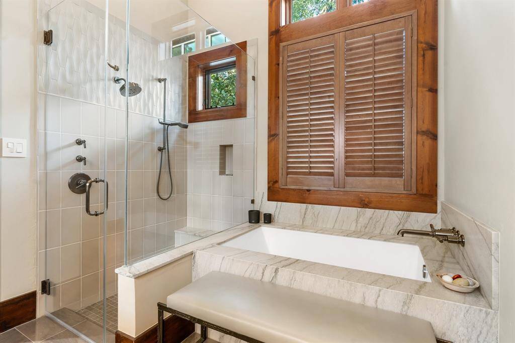 Primary Spa Bath offers natural light to all areas showcasing the glass enclosed shower and soaking tub.