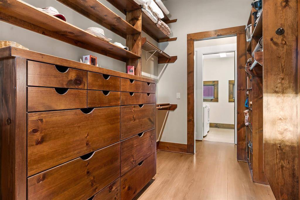 This is just one side of the primary walk-in closet, so well designed with multiple hanging space and built-ins! One enters from Primary bath as well as from the hall with laundry conveniently across.