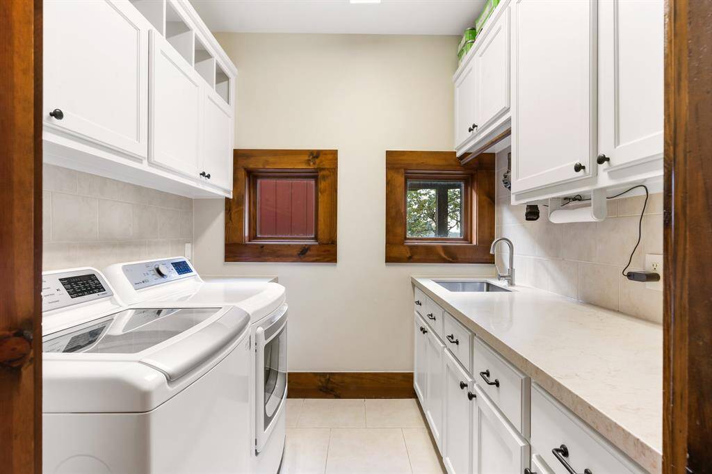 The laundry area has 2 windows overlooking the courtyard, a deep sink and amazing storage!