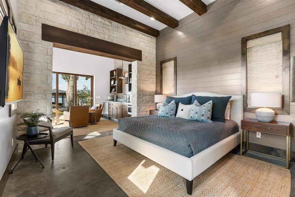 The Bedroom is dressed with stone and beam accents.