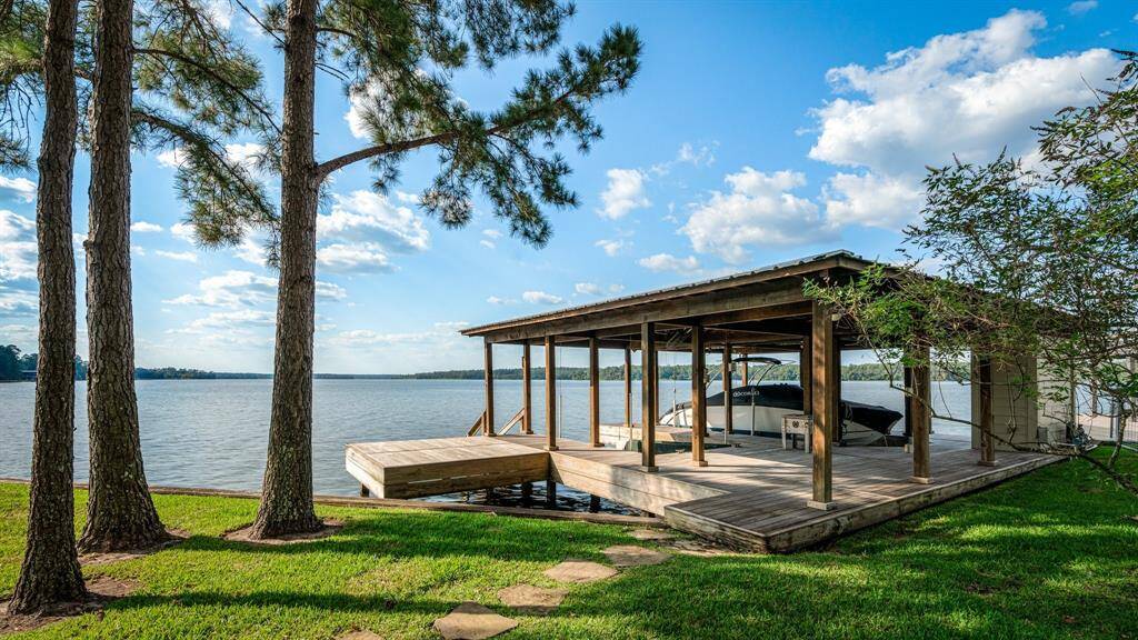 The wooden boat house has 2 slips with lifts. One is designed to hold a Cobalt boat,( possibly for sale also) and the other configured for dual jet skis. Look at the miles of view!
