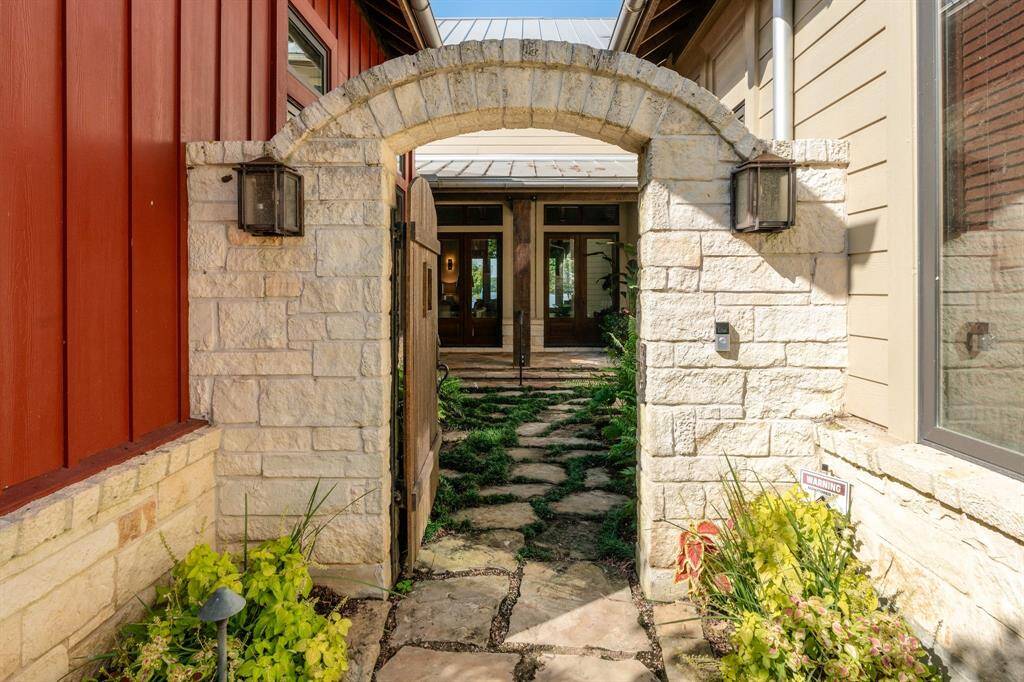 Private, gated entrance opens to the court yard to the front door