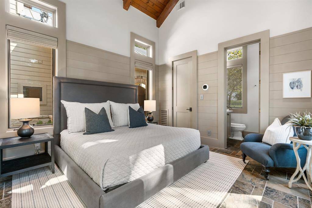 Front Private Suite is spacious with dramatic ceiling, slate flooring, closet and full bath. Perfect for special guests or a second Primary suite.