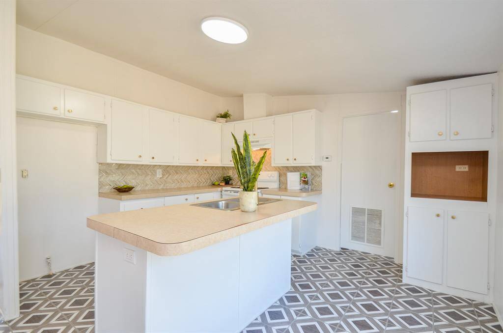 Oversized island with large updated kitchen with space for coffee bar